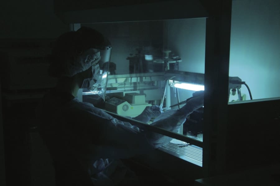 Person working in a dark laboratory.