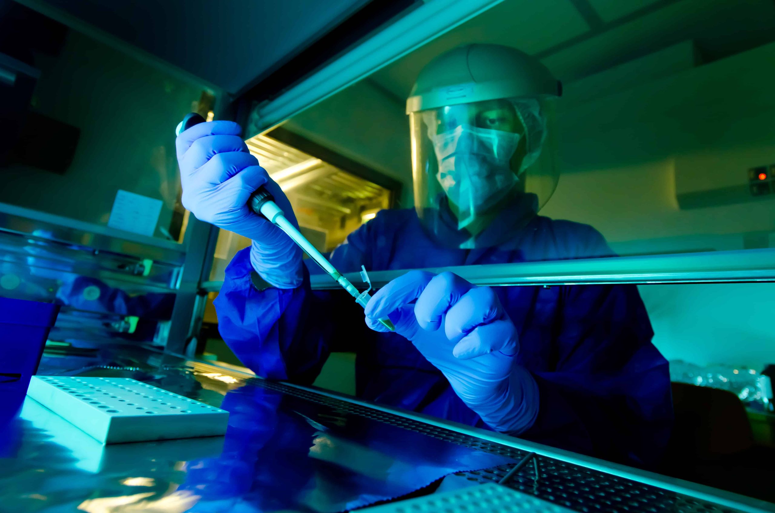 Person working in a laboratory with laboratory equipment.