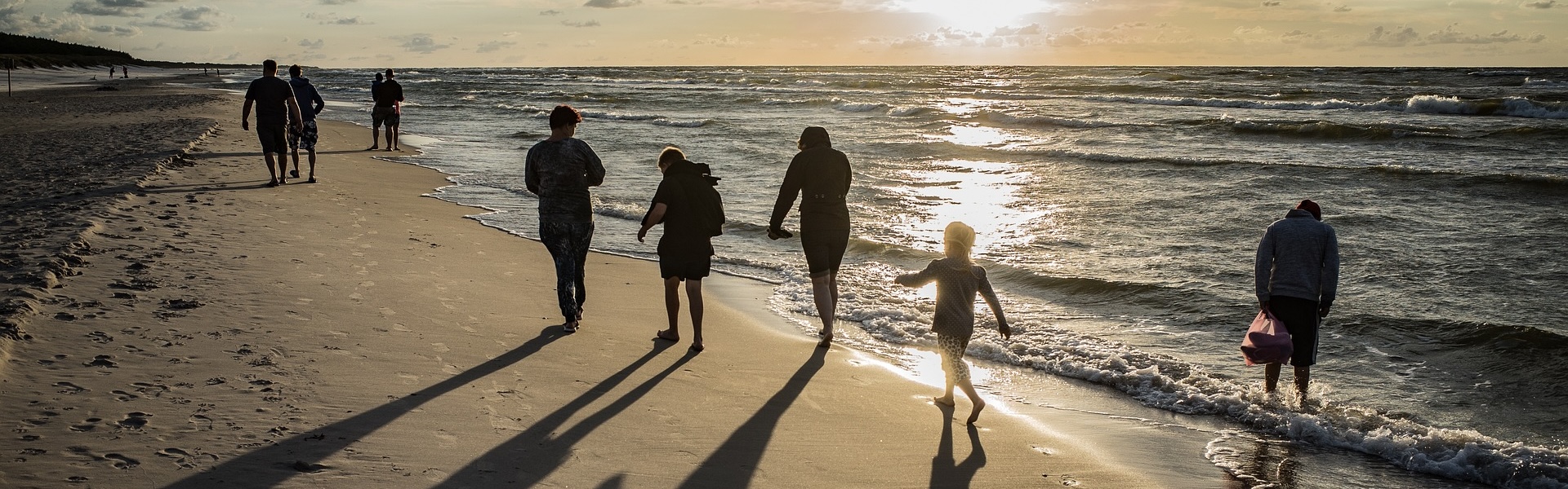 families and couples at the beach at sunrise