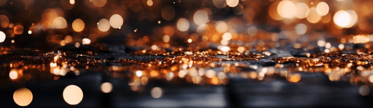 gold glitter falling on a black surface
