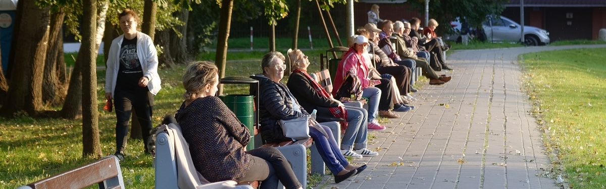 seniors sitting on fully packed benches